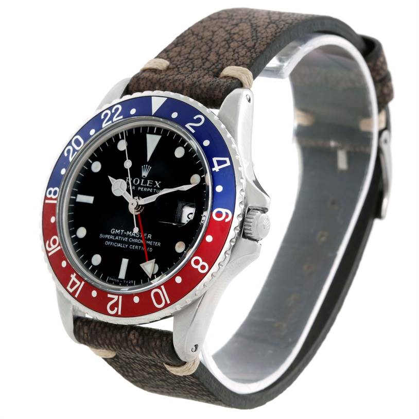 The Vintage Collection Rolex GMT-Master watch is shown from a front-right angle, featuring a Pepsi bezel and leather strap.