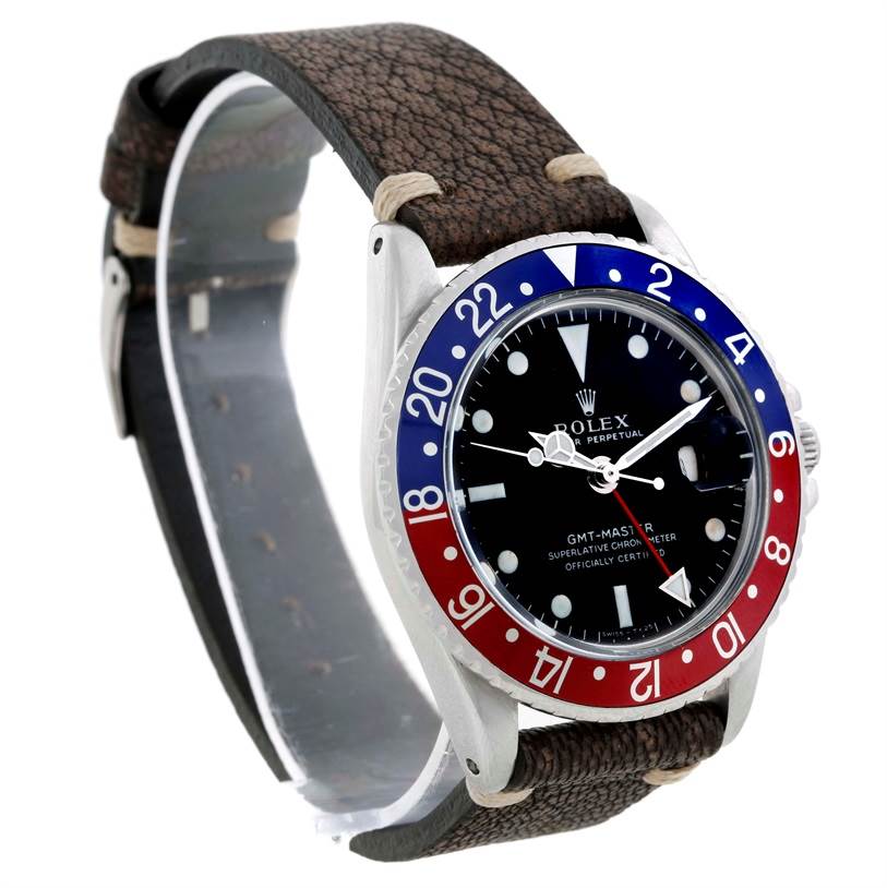 The image shows a Rolex GMT-Master Vintage Collection watch from a front angle, highlighting its dial and a two-tone bezel.