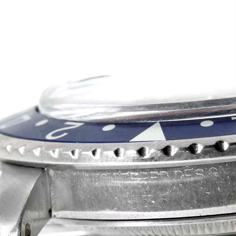 The image shows a close-up side angle of the bezel, crystal, and part of the case of a Rolex Vintage Collection 1675 Men's Stainless Steel Black Dial 1675 Men's Stainless Steel Black Dial watch.