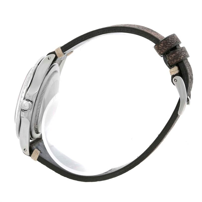 The image shows a side view of the Rolex Vintage Collection 1675 Men's Stainless Steel Black Dial 1675 Men's Stainless Steel Black Dial watch, displaying the case, crown, and leather strap with a buckle.