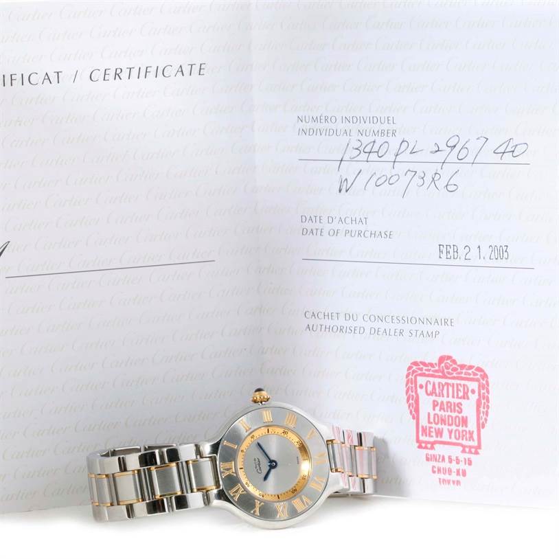The Cartier Must 21 W10073R6 Women
s Stainless Steel Silver Dial W10073R6 Women
s Stainless Steel Silver Dial watch is shown from the front, placed in front of its certificate of Best Quality
ity.
