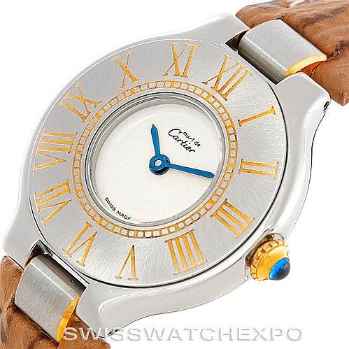 The image shows a close-up of the Cartier Must 21 W1007323 Men's Stainless Steel Silver Dial W1007323 Men's Stainless Steel Silver Dial watch face, showcasing its dial, Roman numerals, hands, and part of the leather strap.