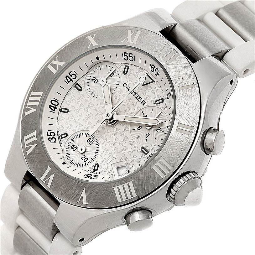 The image shows a Cartier Must 21 W10197U2 Women's Stainless Steel Silver Dial W10197U2 Women's Stainless Steel Silver Dial watch at an angled close-up, displaying the dial, bezel, chronograph buttons, and part of the bracelet.