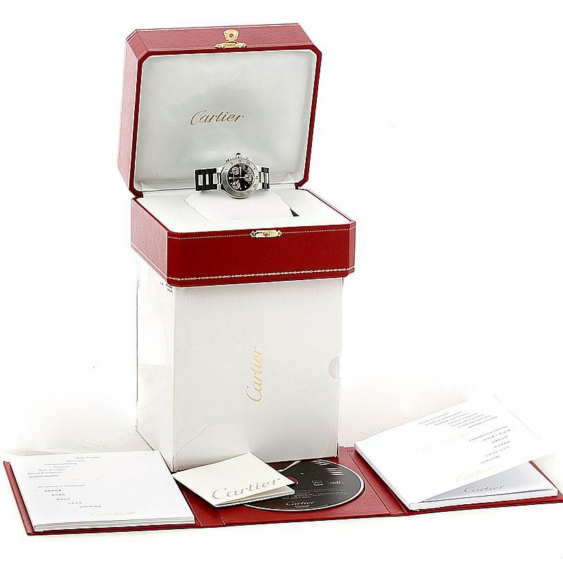 The Must 21 model by Cartier is displayed in its open red case with accompanying booklets and a CD.