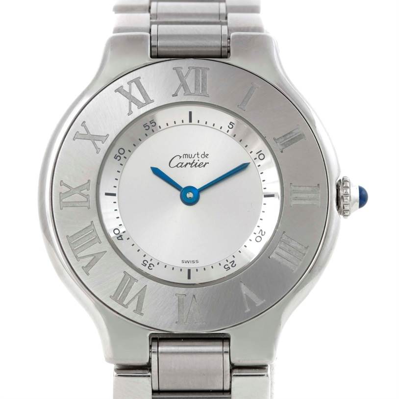 The Cartier Must 21 W10109T2 Women's Stainless Steel Silver Dial W10109T2 Women's Stainless Steel Silver Dial watch is shown from a front angle, displaying its silver dial, blue hands, Roman numeral markers, and metal bracelet.
