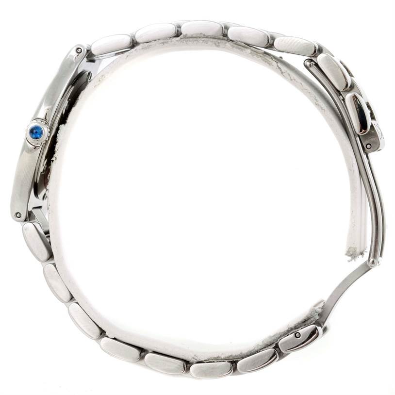 The image shows a Cartier Must 21 W10109T2 Women's Stainless Steel Silver Dial W10109T2 Women's Stainless Steel Silver Dial watch from a side angle, highlighting its metal bracelet and side profile, including the crown with a blue stone.