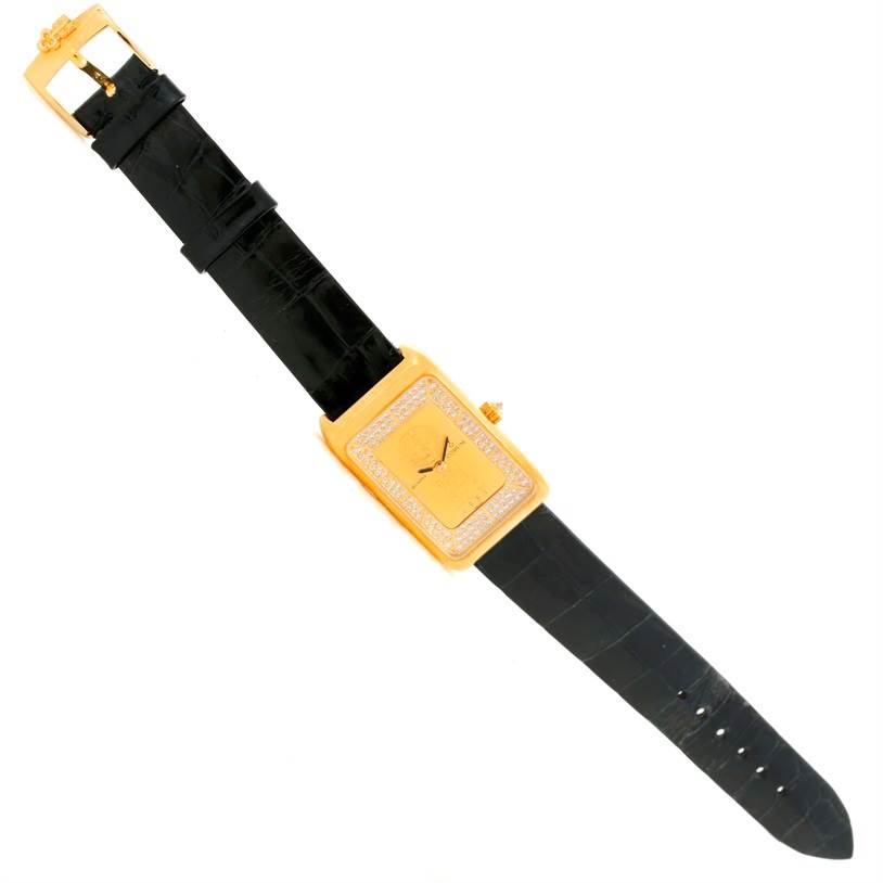 The Corum Women's Yellow Gold Champagne Dial Women's Yellow Gold Champagne Dial 18K Yellow Gold Diamond 5 Gram Ingot 999.9 watch is shown from a top view, displaying its rectangular face and black leather strap.