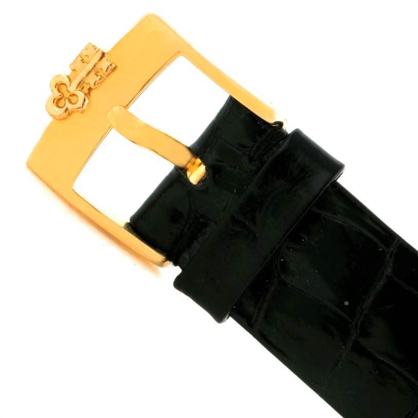 The image shows the gold buckle and black strap of the Corum Women's Yellow Gold Champagne Dial Women's Yellow Gold Champagne Dial 18K Yellow Gold Diamond 5 Gram Ingot 999.9 Watch.