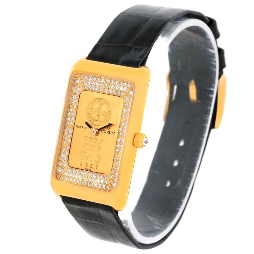The Corum Women's Yellow Gold Champagne Dial Women's Yellow Gold Champagne Dial 18K Yellow Gold Diamond 5 Gram Ingot 999.9 Watch is shown at a tilted side angle, displaying its face, dial, and leather strap.