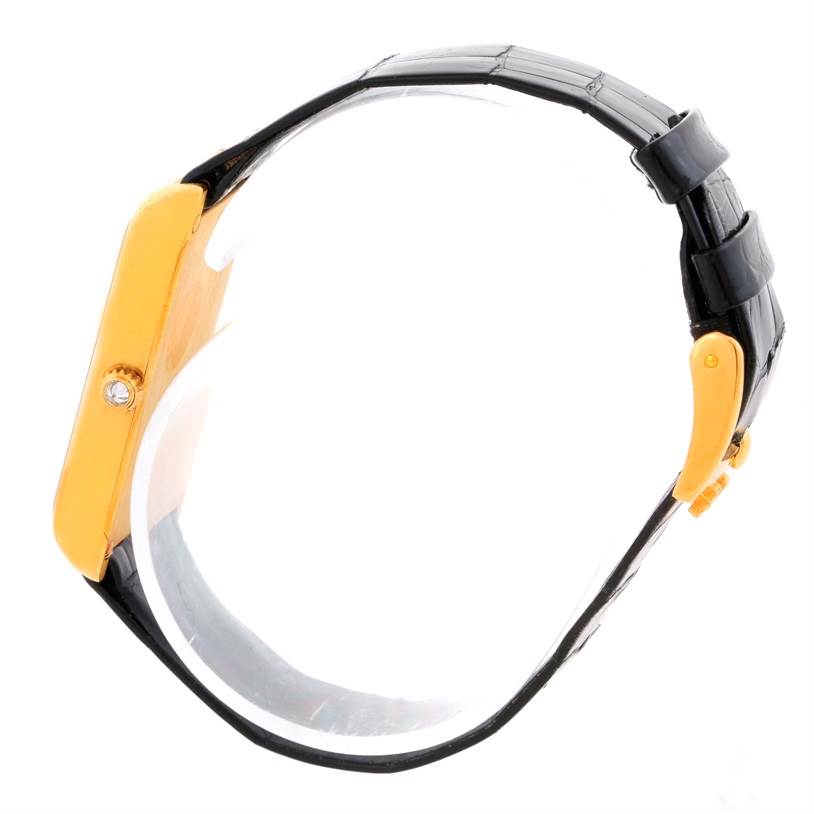 This side view of the Corum Women's Yellow Gold Champagne Dial Women's Yellow Gold Champagne Dial 18K Yellow Gold Diamond 5 Gram Ingot 999.9 Watch shows the case, crown, and strap.