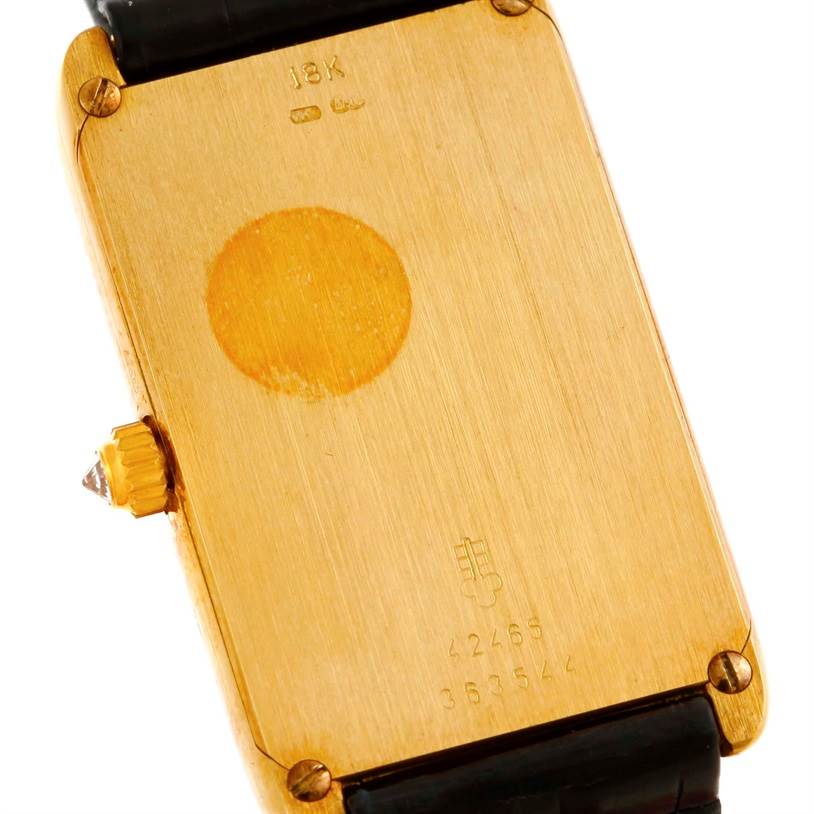 This image shows the back of the Corum Women's Yellow Gold Champagne Dial Women's Yellow Gold Champagne Dial 18K Yellow Gold Diamond 5 Gram Ingot 999.9 Watch, including the serial number and a diamond-encrusted crown.