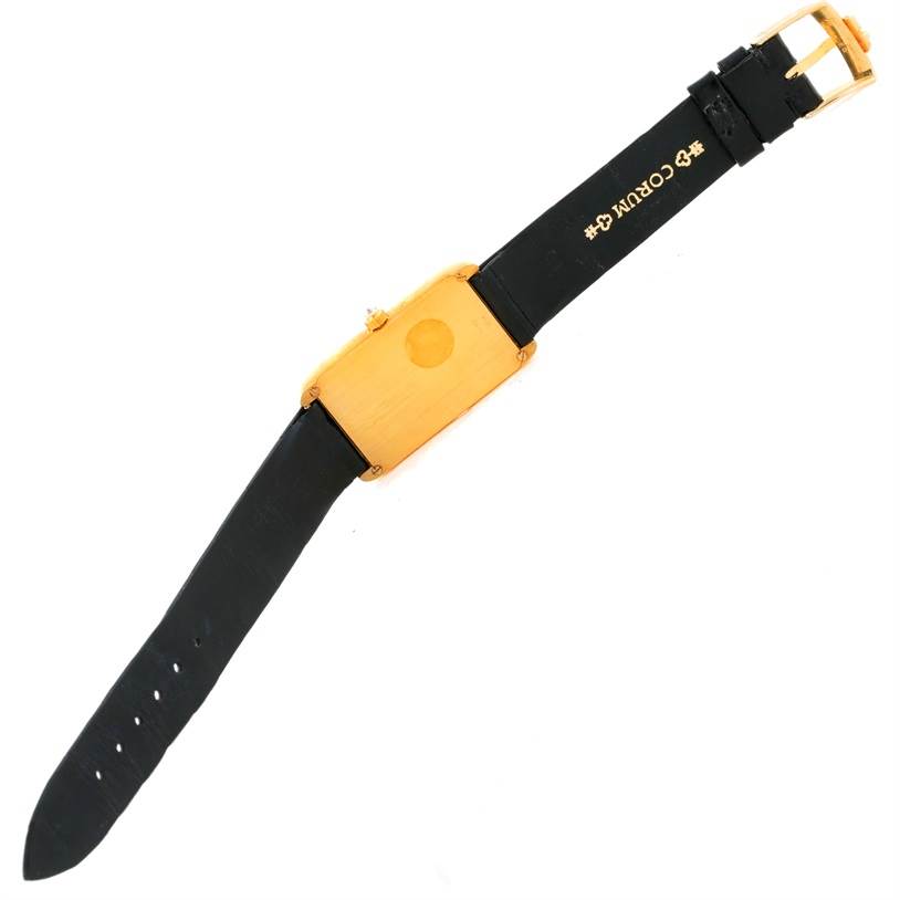 This image shows a top view of the Corum Women's Yellow Gold Champagne Dial Women's Yellow Gold Champagne Dial 18K Yellow Gold Diamond 5 Gram Ingot 999.9 Watch with a black strap and gold buckle.