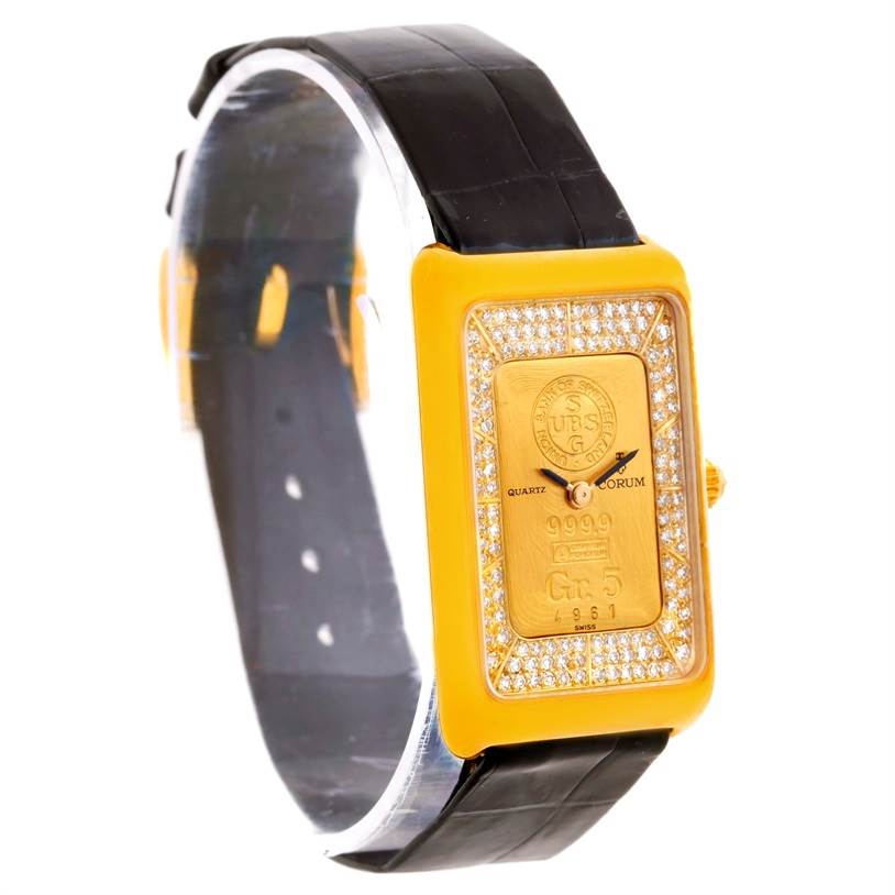 The 18K Yellow Gold Diamond 5 Gram Ingot 999.9 Watch by Corum Women's Yellow Gold Champagne Dial Women's Yellow Gold Champagne Dial is shown at a slight angle, highlighting the face, bezel, and black strap.