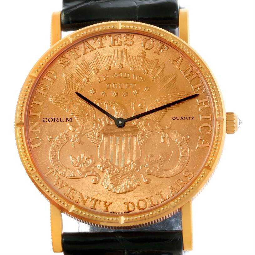 The image shows a Corum Coin Watch 4414556 Men
s Yellow Gold Black Dial 4414556 Men
s Yellow Gold Black Dial model from the front angle, displaying its face, time hands, and part of the strap.