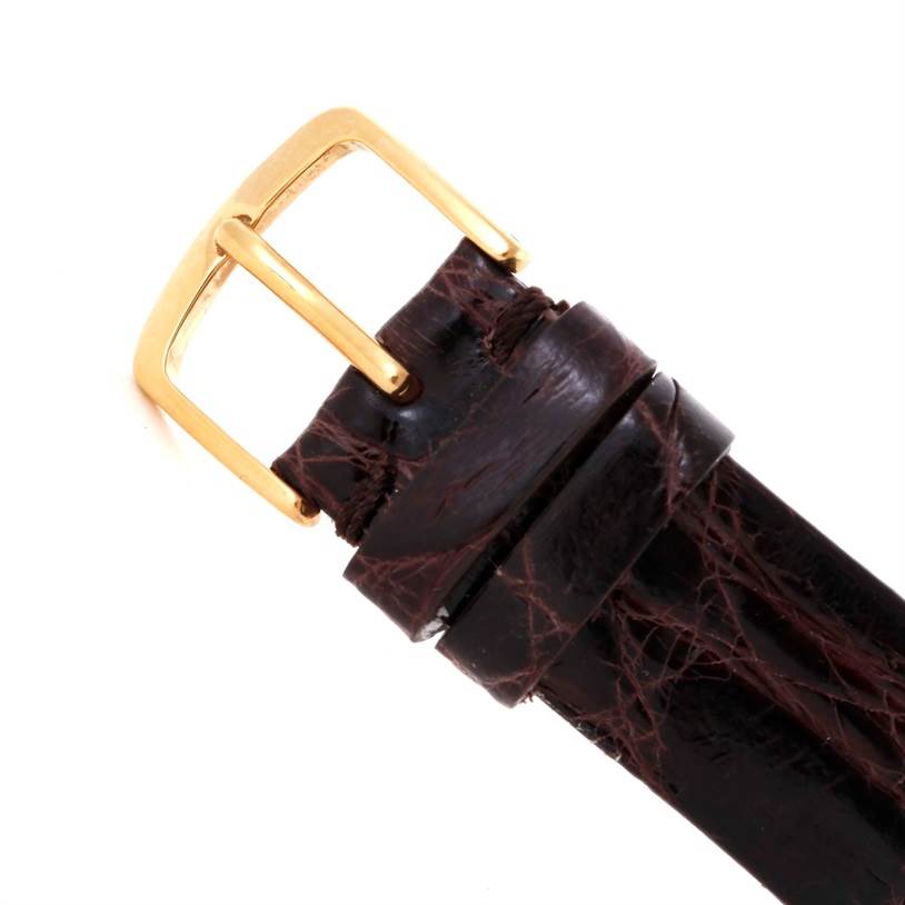 The image shows the buckle and top portion of a leather strap of a Corum Coin Watch Men's Yellow Gold Black Dial Men's Yellow Gold Black Dial.