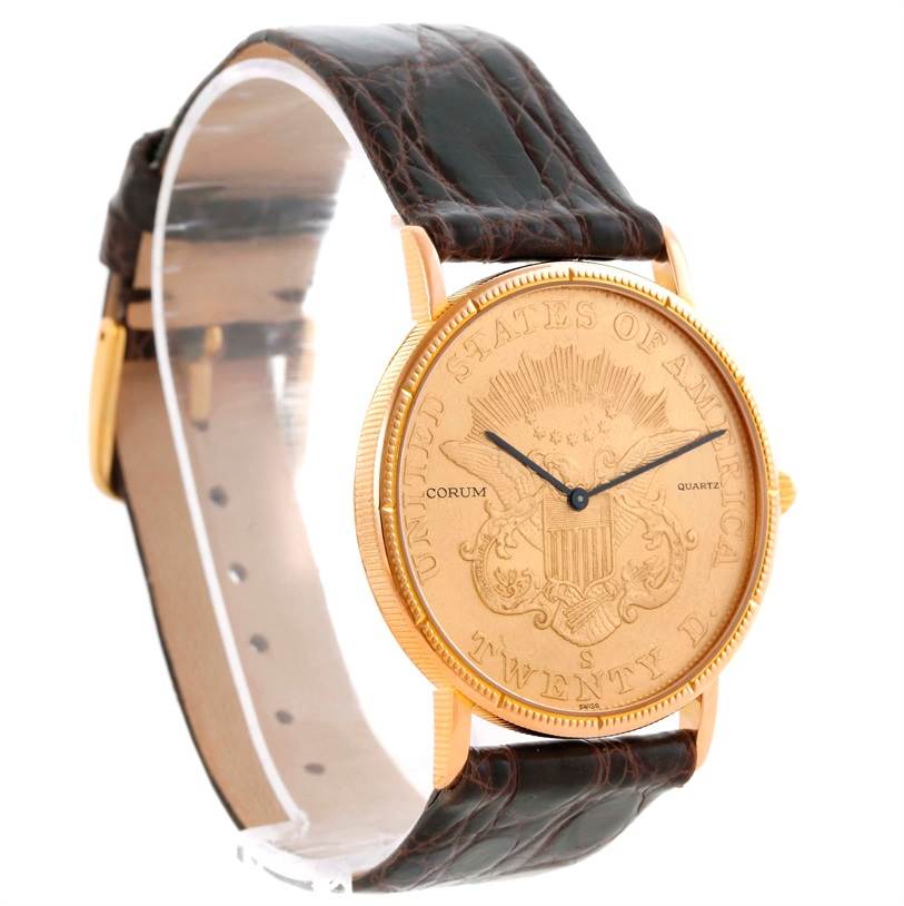 The image shows a side view of the Corum Coin Watch Men's Yellow Gold Black Dial Men's Yellow Gold Black Dial model, highlighting its face, casing, and partially the leather strap.