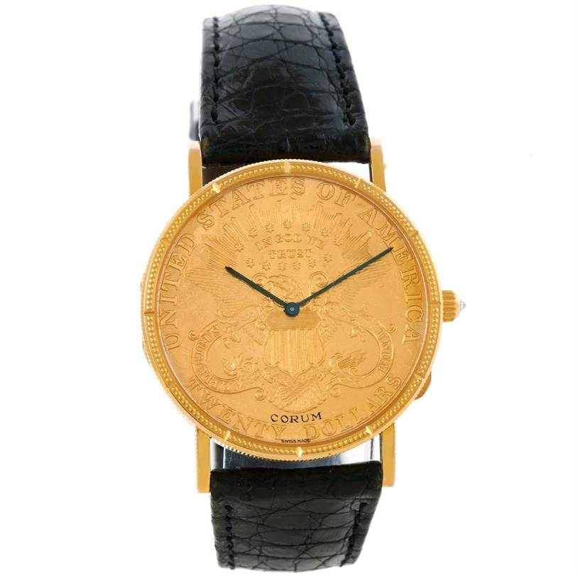 The image shows a frontal view of a Corum Coin Watch Men's Yellow Gold Black Dial Men's Yellow Gold Black Dial model, displaying the watch face and black leather strap.