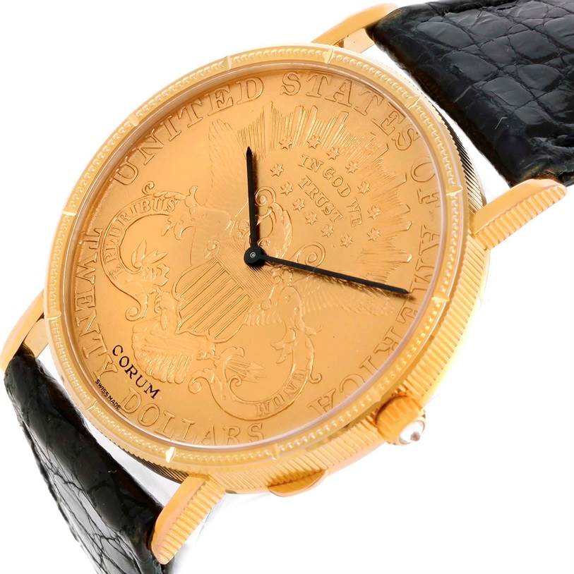 The image shows a close-up view of the Corum Coin Watch Men's Yellow Gold Black Dial Men's Yellow Gold Black Dial model, highlighting its face and part of the black strap.