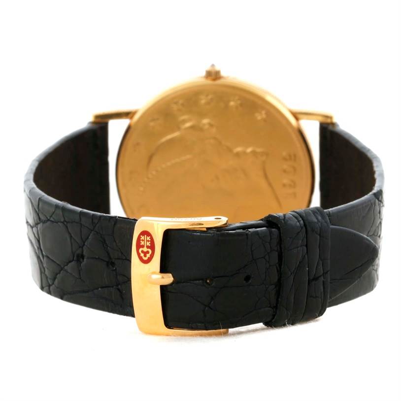 The image shows the back view of a Corum Coin Watch Men
s Yellow Gold Black Dial Men
s Yellow Gold Black Dial model, focusing on the black leather strap and gold buckle.