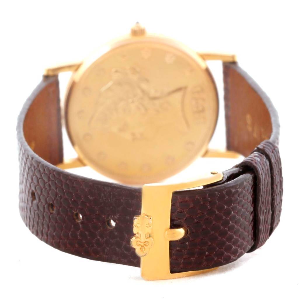 The image shows the back and brown leather strap of the Corum Women's Yellow Gold Black Dial Women's Yellow Gold Black Dial 18K Yellow Gold 10 Dollars Coin Diamond Ladies Watch.