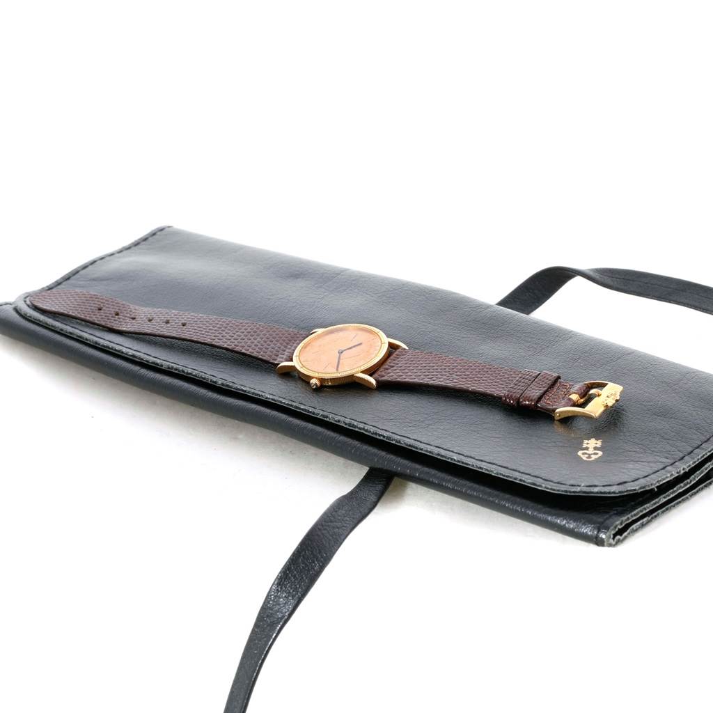 The Corum Women's Yellow Gold Black Dial Women's Yellow Gold Black Dial 18K Yellow Gold 10 Dollars Coin Diamond Ladies Watch is shown from an angled top view, resting on a black case.