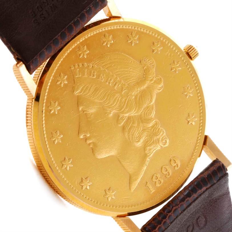 This image shows the gold coin face of the Corum Yellow Gold Black Dial Yellow Gold Black Dial 20 Dollars Double Eagle Yellow Gold Coin Brown Strap Watch at a slight side angle.