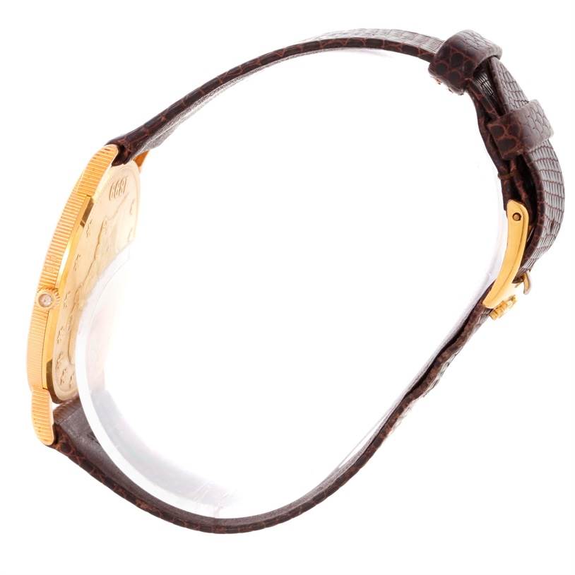 The image shows a side view of the Corum Yellow Gold Black Dial Yellow Gold Black Dial 20 Dollars Double Eagle Yellow Gold Coin Brown Strap Watch, highlighting its gold case and brown strap.