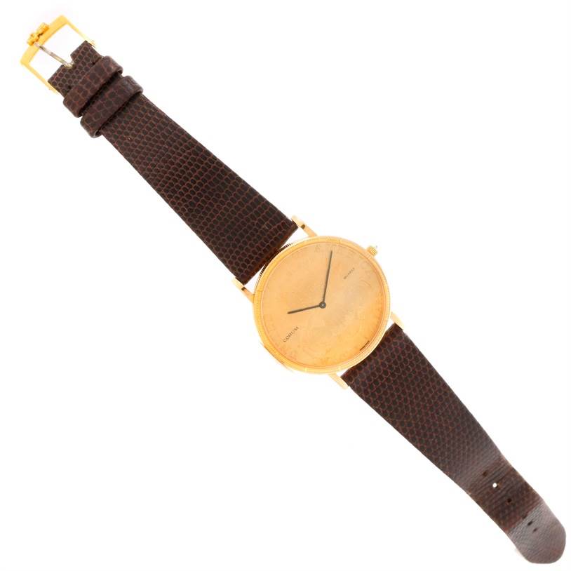 The Corum Yellow Gold Black Dial Yellow Gold Black Dial 20 Dollars Double Eagle Yellow Gold Coin Brown Strap Watch is shown from a top-down angle, displaying the face and the band.