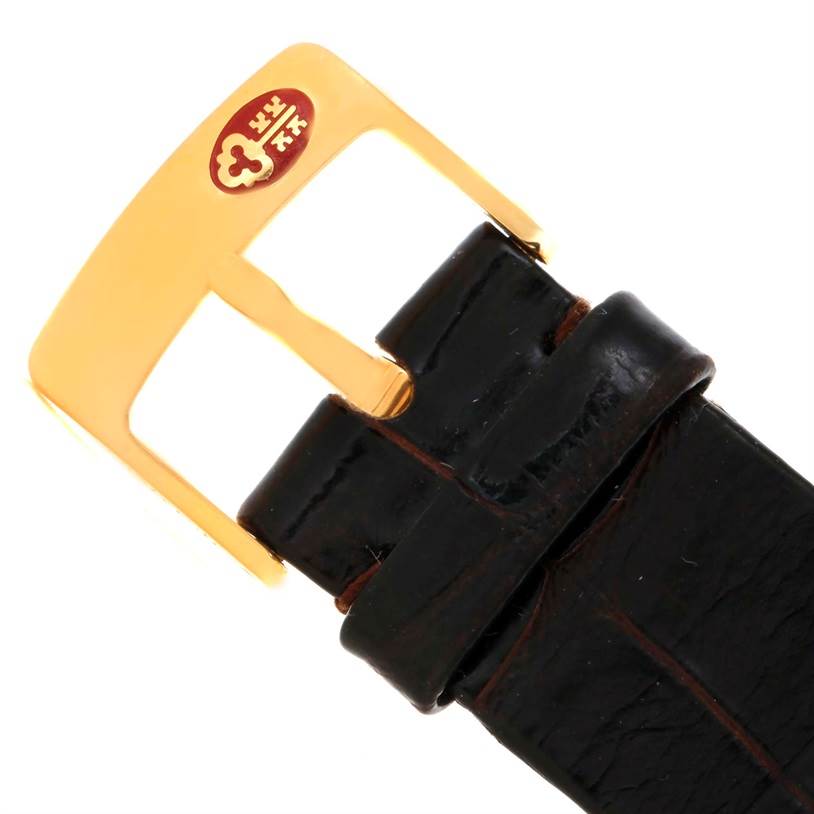 The image shows a close-up view of a black leather strap and gold-hued buckle of a Corum Coin Watch Men's Yellow Gold Black Dial Men's Yellow Gold Black Dial model.