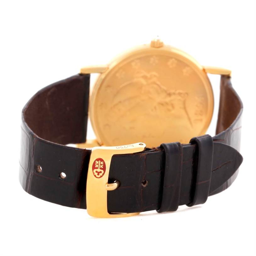 The image shows a rear angle of the Corum Coin Watch Men's Yellow Gold Black Dial Men's Yellow Gold Black Dial model, highlighting its back case and leather strap with a gold buckle.