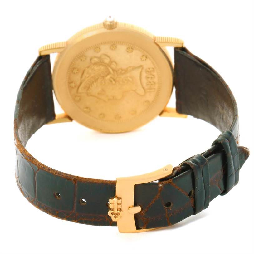 This image shows the back of the Corum Yellow Gold Black Dial Yellow Gold Black Dial 1893 18K Yellow Gold 10 Coin Diamond Watch and its black leather strap from a rear angle.