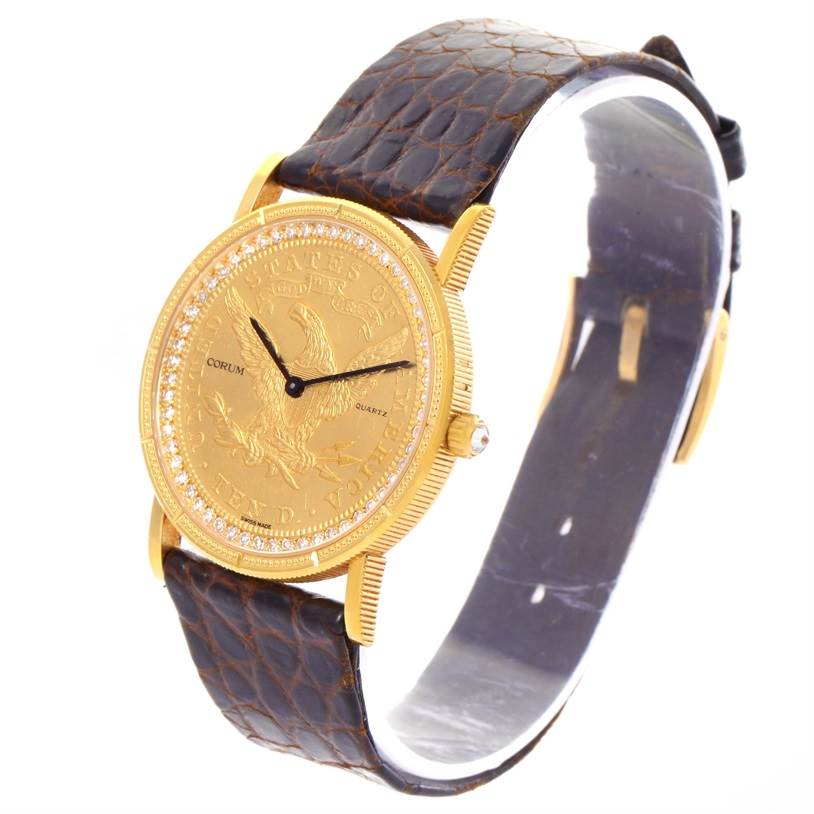 The 1893 18K Yellow Gold 10 Coin Diamond Watch by Corum Yellow Gold Black Dial Yellow Gold Black Dial is shown at a slight angle highlighting its face, bezel, and leather strap.