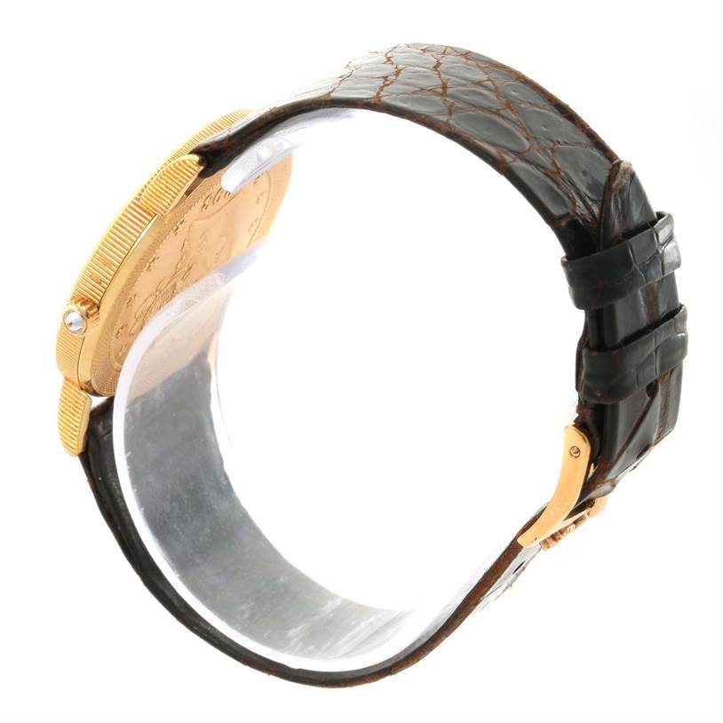 The image shows a side view of the Corum Yellow Gold Black Dial Yellow Gold Black Dial 1893 18K Yellow Gold 10 Coin Diamond Watch, highlighting the strap and side profile of the case.