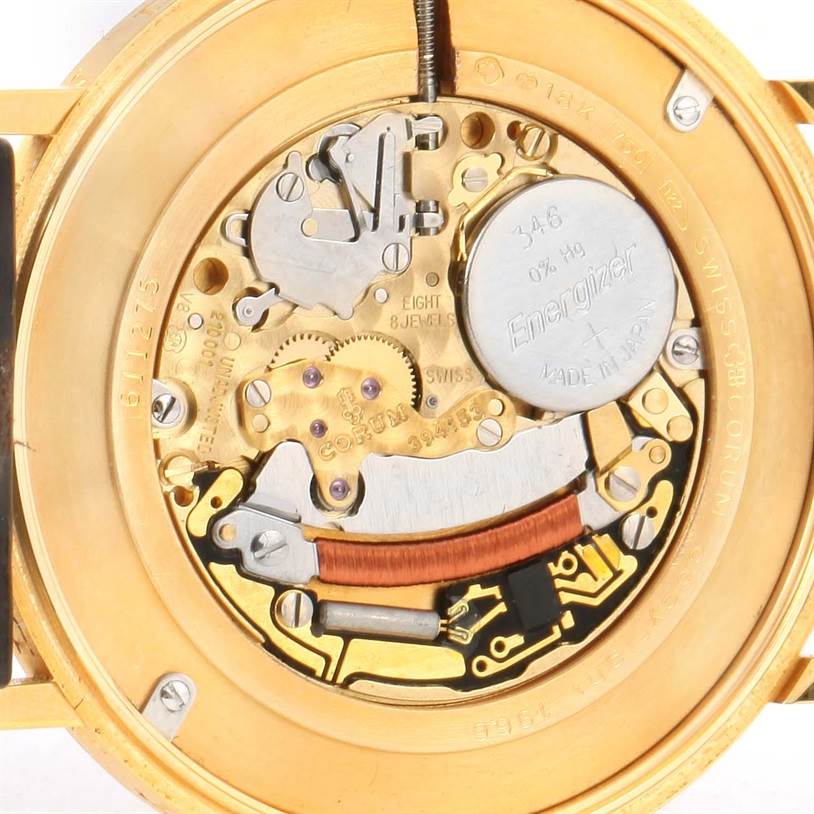 The image shows a close-up of the internal mechanics and battery of a Corum Coin Watch Men's Yellow Gold Champagne Dial Men's Yellow Gold Champagne Dial model.