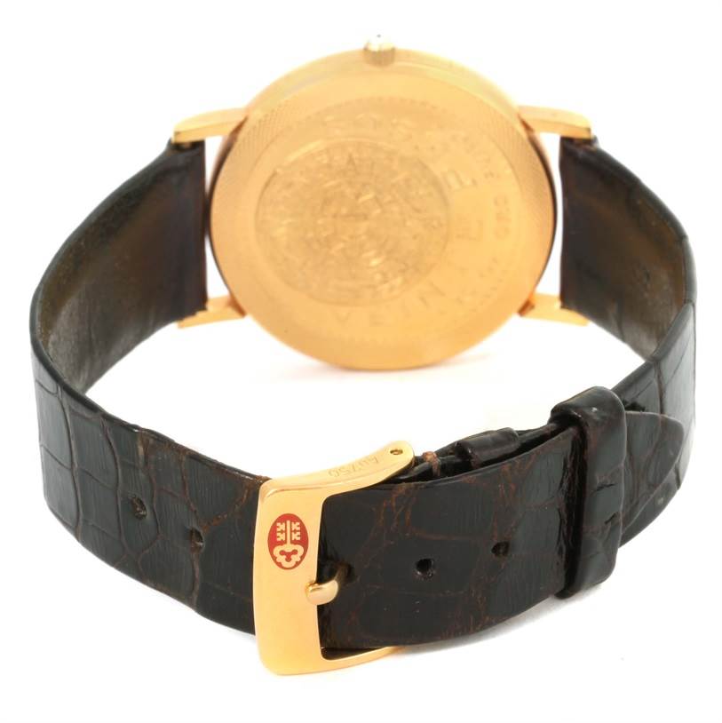 The image shows the back view of the Coin Watch model by Corum, highlighting the strap and buckle.