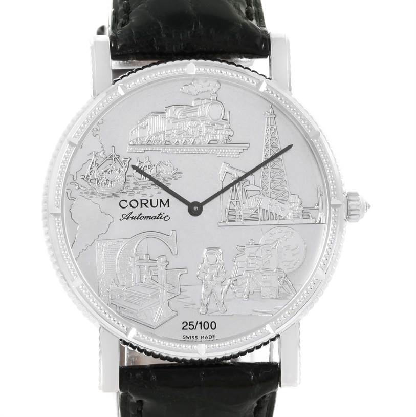 The image shows a front view of the Corum Men's White Gold White Dial Men's White Gold White Dial Celebrates Second Millennium 18K White Gold Automatic LTD Watch with a detailed face and black strap.