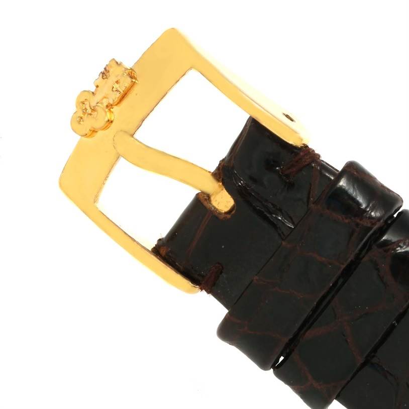 The image shows a close-up of the leather strap and gold buckle of a Corum Coin Watch Men's Yellow Gold Black Dial Men's Yellow Gold Black Dial model.