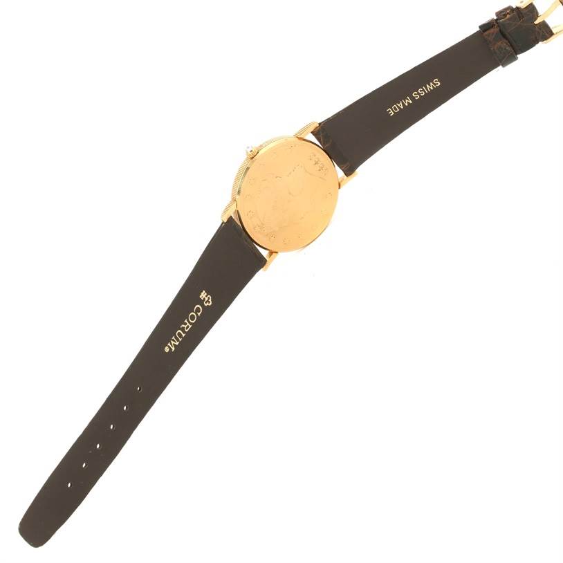 This image shows the back of a Corum Coin Watch Men's Yellow Gold Black Dial Men's Yellow Gold Black Dial model with its leather strap fully extended.
