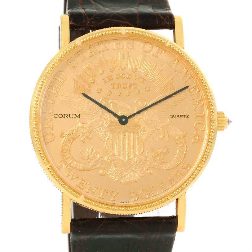 The image shows a frontal view of a Corum Coin Watch Men's Yellow Gold Black Dial Men's Yellow Gold Black Dial model, featuring a gold coin dial and a leather strap.