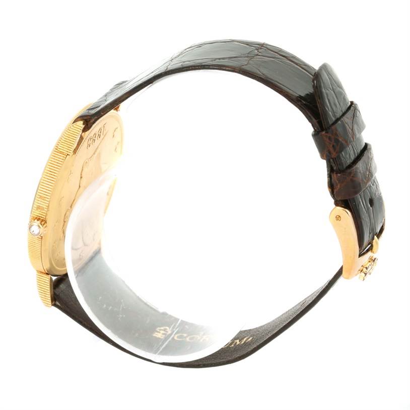 Side view of the Corum Coin Watch Men's Yellow Gold Black Dial Men's Yellow Gold Black Dial model showcasing the gold case, black leather strap, and buckle.