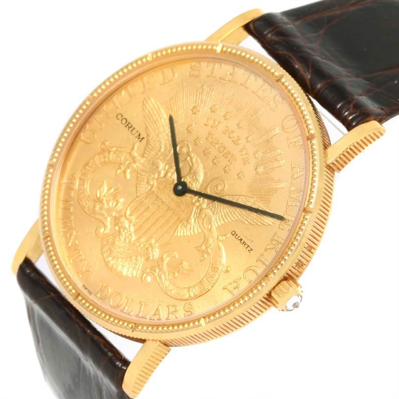 The image shows a Corum Coin Watch Men's Yellow Gold Black Dial Men's Yellow Gold Black Dial model from an angled top view, displaying the dial, crown, and part of the leather strap.