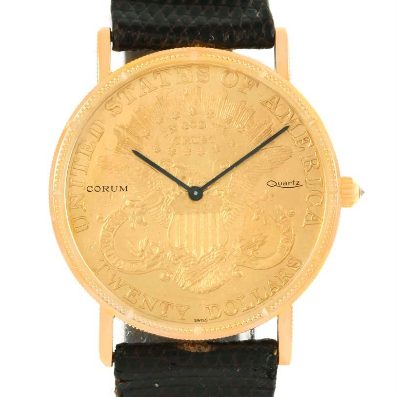 The watch is a Corum Coin Watch Men's Yellow Gold Black Dial Men's Yellow Gold Black Dial model shown from the front, displaying its gold-tone case, dial, and black strap.