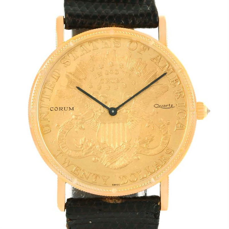 The watch is a Corum Coin Watch model shown from the front, displaying its gold-tone case, dial, and black strap.