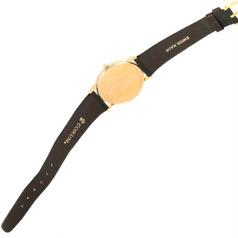 This image shows the back and straps of the Corum Coin Watch Men's Yellow Gold Black Dial Men's Yellow Gold Black Dial model, displaying the leather bands and engraved case back.