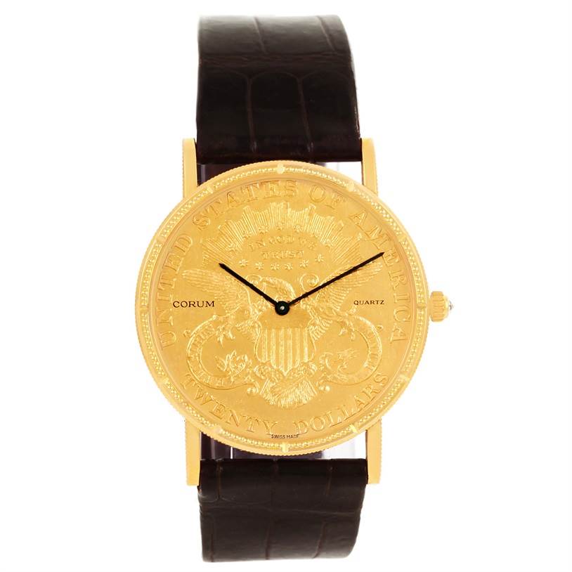 The image shows a front view of the Corum Coin Watch Men's Yellow Gold Black Dial Men's Yellow Gold Black Dial, featuring a gold dial and black leather strap.