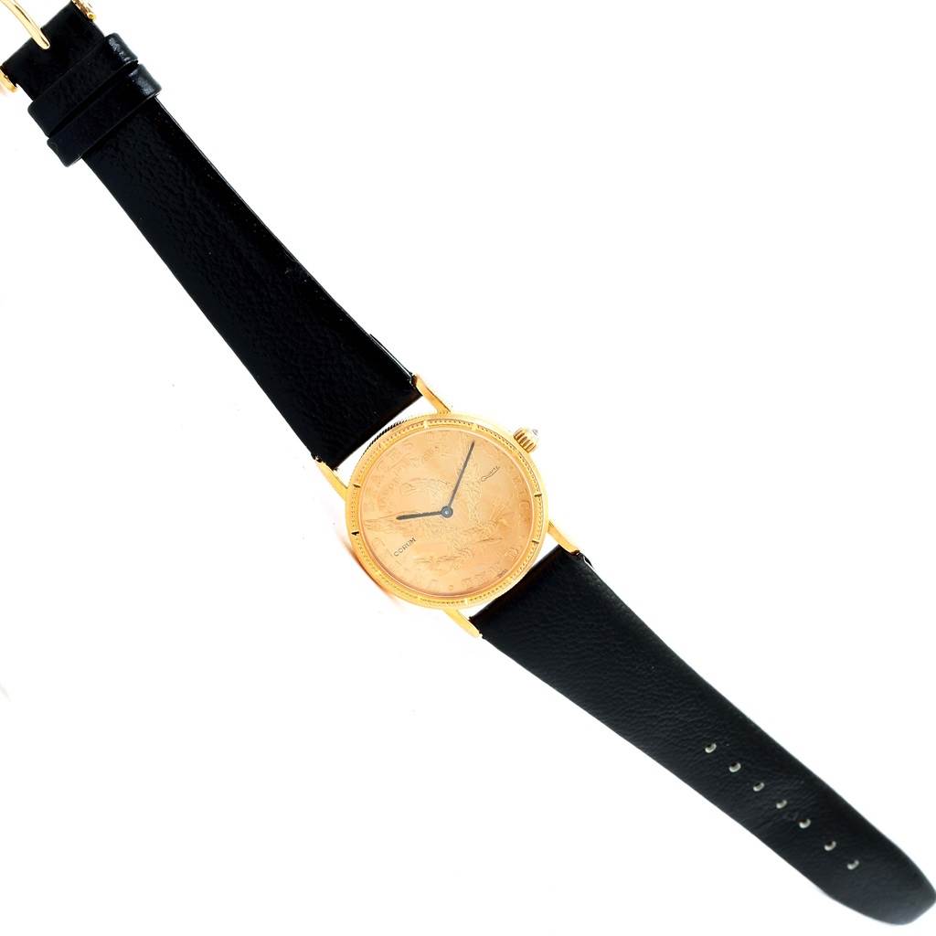 The image shows a top view of the Corum Women's Yellow Gold Black Dial Women's Yellow Gold Black Dial 18K Yellow Gold 10 Dollars Coin Ladies Watch with black leather straps.