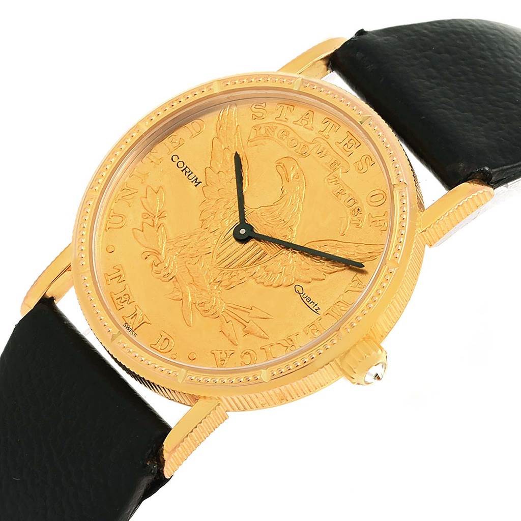 The image shows the Corum Women's Yellow Gold Black Dial Women's Yellow Gold Black Dial 18K Yellow Gold 10 Dollars Coin Ladies Watch model from an angled top-down view, highlighting its face and strap.