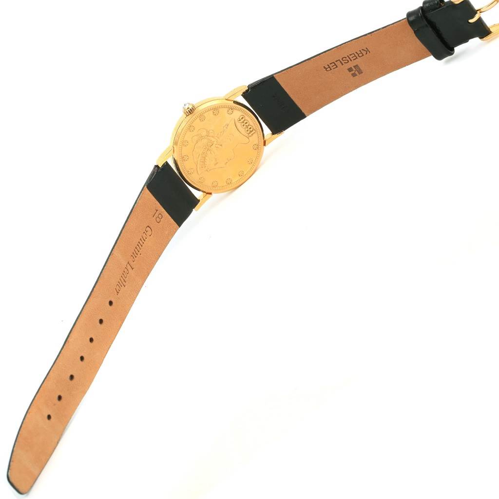 The image shows a top view of the Corum Women's Yellow Gold Black Dial Women's Yellow Gold Black Dial 18K Yellow Gold 10 Dollars Coin Ladies Watch, displaying its dial and leather strap.