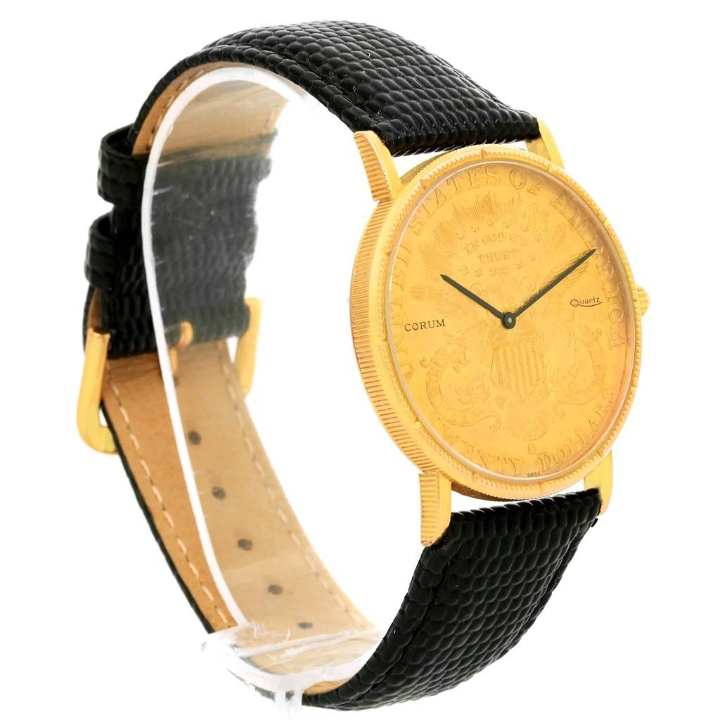 The image shows a Corum Coin Watch Men's Yellow Gold Black Dial Men's Yellow Gold Black Dial model at a slight angle, highlighting its gold face, black leather strap, and minimalist design.