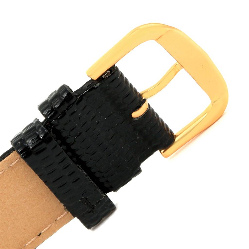 This image shows the black leather strap and gold buckle of the Corum Coin Watch Men's Yellow Gold Black Dial Men's Yellow Gold Black Dial model.